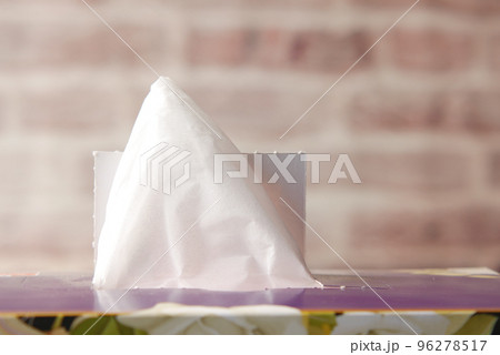 hand pull out a piece of tissue from tissue paper box  96278517