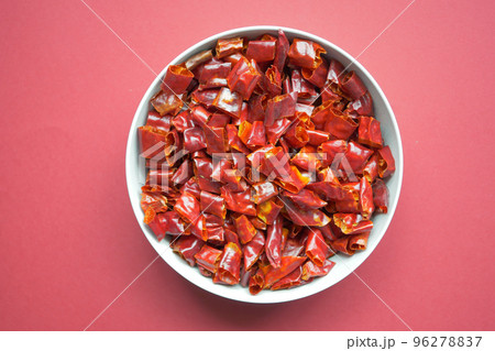 top view of large chili flakes on red background top view of large chili flakes on red background 96278837