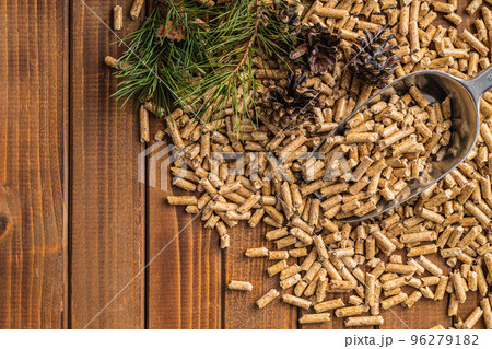 Wooden pellets in scoop on wooden table. Top view. Wooden pellets in scoop on wooden table. Top view. 96279182