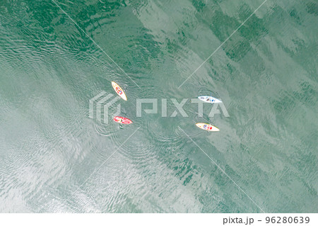 Aerial top down view of sport canoes rowing on the Broken Bow lake, Oklahoma, USA. Kayaking on lake, photo from drone. Aerial top down view of sport canoes rowing on the Broken Bow lake, Oklahoma, USA. Kayaking on lake, photo from drone. 96280639