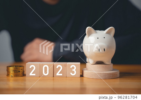Happy New Year 2023. Businessman with wood cubes block number years 2023 and piggy bank to setting target plan business goal, Start finance success business, save money 96281704