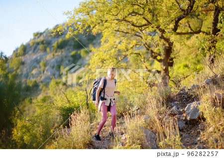 Young woman hiking on mountains in Europe. Concepts of adventure, extreme survival, orienteering. Single travel. 96282257