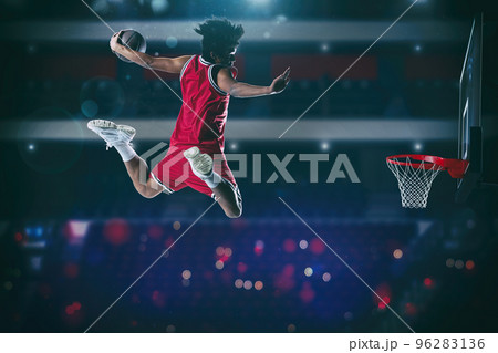 Basketball game with a high jump player to make a slam dunk to the basket 96283136
