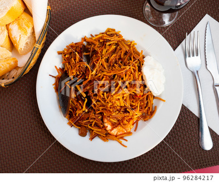 Dish of Valencian cuisine Fideua with seafood and noodles 96284217