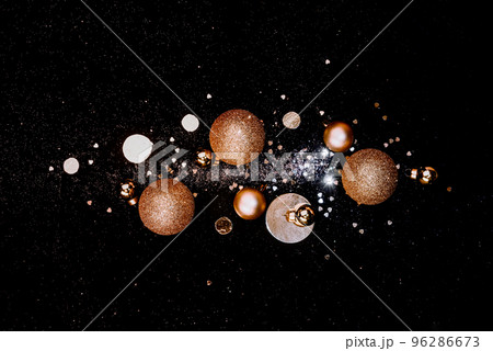 Festive composition of golden Christmas balls, decorations, shiny ornament Festive composition of golden Christmas balls, decorations, shiny ornament 96286673