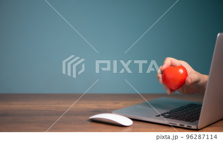 Red heart stick out of a laptop computer screen,  giving, donation, insurance, love chat online dating concept. 96287114