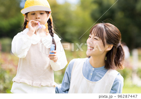 公園で遊ぶ保育士と園児 96287447