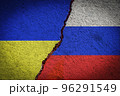 Russia and Ukraine war conflict. Ukrainian and Russian flag on a cracked stone wall. War, crisis, aggression concept. 96291549