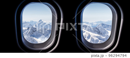 Mountains view through jet plane windows high on the sky. Winter snowy mountains Mountains view through jet plane windows high on the sky. Winter snowy mountains 96294794