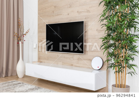 Living room with couch and led tv on wooden wall 96294841