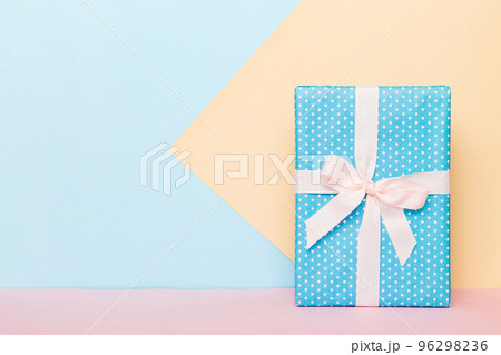 holiday handmade paper present tied white ribbon bow top view with copy space. Flat lay holiday background. Birthday or christmas present. Christmas gift box concept with copy space 96298236