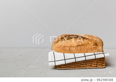 Freshly baked bread on basket against natural background. Perspective view bread copy space Freshly baked bread on basket against natural background. Perspective view bread copy space 96298588