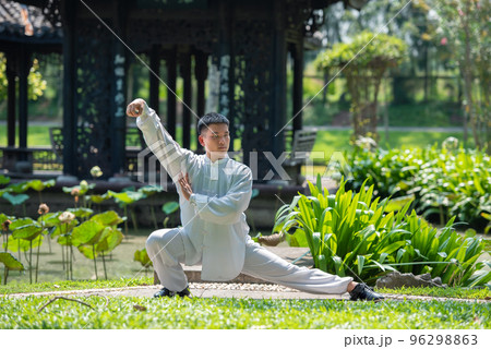 Asian man workout with Tai Chi in the morning at the park, Chinese martial arts, healthy care for healthy life concept. 96298863