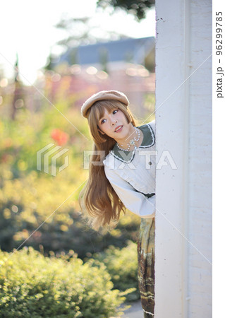 A beautiful woman in lolita dress in garden background Japanese street fashion portrait 96299785