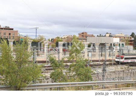Train. Train tracks. Train entering a station. Subway leaving the station. Means of transport in Madrid, in Spain. Horizontal photography. Train. Train tracks. Train entering a station. Subway leaving the station. Means of transport in Madrid, in Spain. Horizontal photography. 96300790