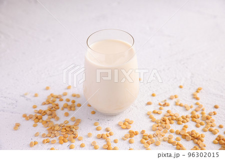 Soy milk in glass and soy bean isolated in white background Soy milk in glass and soy bean isolated in white background 96302015