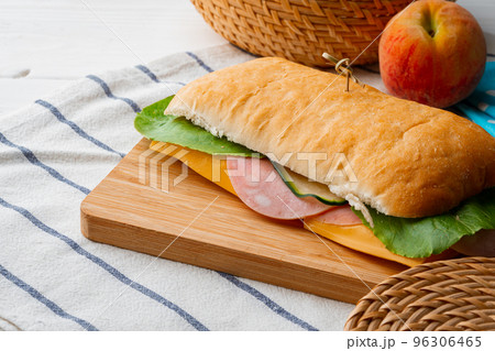 Fresh sandwich with sausage and lettuce on table 96306465