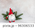 Christmas dwarf in red hat with fir branch holiday card on light winter background 96306533
