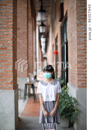 Portrait young woman with mask shopping at community mall on urban in covid-19 virus outbreak 96307949
