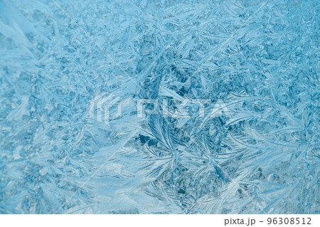 Frosty patterns on glass. Christmas background. Blue ice on winter window. Frosty patterns on glass. Christmas background. Blue ice on winter window. 96308512