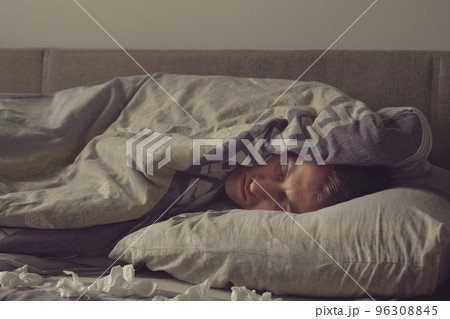 sick young man sleeps in bed 96308845