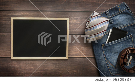 Men's necktie and accessories on Brown background with chalkboard with place for text. 96309337
