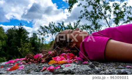 sleeping girl with a happy face on a stone sleeping girl with a happy face on a stone 96309881