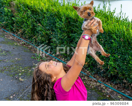 girl with a puppy in her arms 96309884