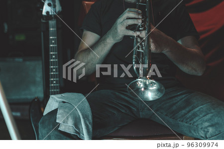 Man blows the trumpet 96309974