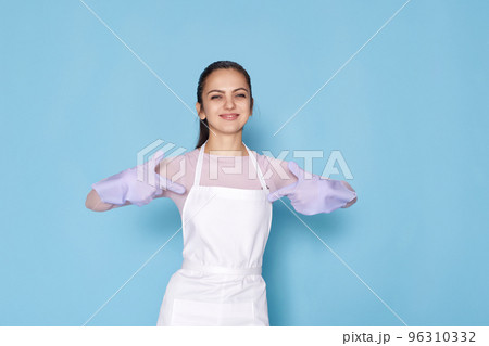 smiling caucasian woman in gloves pointing oneself with fingers 96310332