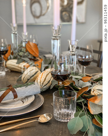 Thanksgiving table setting with fresh pumpkins and flowers in room 96311459