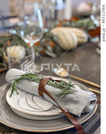 Thanksgiving table setting with fresh pumpkins and flowers in room Thanksgiving table setting with fresh pumpkins and flowers in room 96311466