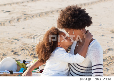 Loving African American family on picnic on beach Loving African American family on picnic on beach 96312448