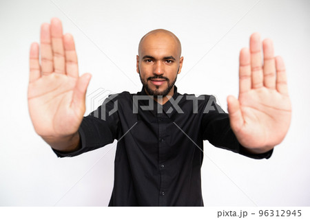 Portrait of confident young businessman making stop gesture Portrait of confident young businessman making stop gesture 96312945