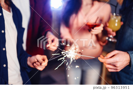 Group of friends having fun with sparklers. young people laugh. celebrating New Year together. Group of friends having fun with sparklers. young people laugh. celebrating New Year together. 96313951