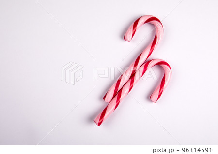 Two red candy canes on a white background Two red candy canes on a white background 96314591