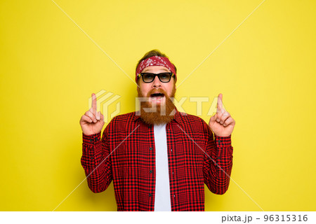 Happy man with beard and bandana in head cries indicates something Happy man with beard and bandana in head cries indicates something 96315316