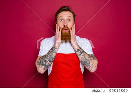 wondered isolated chef with beard and red apron wondered isolated chef with beard and red apron 96315399