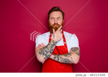 doubter isolated chef with beard and red apron doubter isolated chef with beard and red apron 96315400