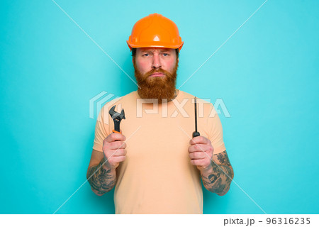 Worker with yellow hat is confused about his work Worker with yellow hat is confused about his work 96316235