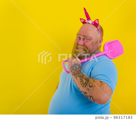 fat man with headband play with sea paddle 96317183