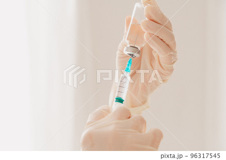 Doctor with syringe is ready to administer the vaccine against covid-19 Doctor with syringe is ready to administer the vaccine against covid-19 96317545