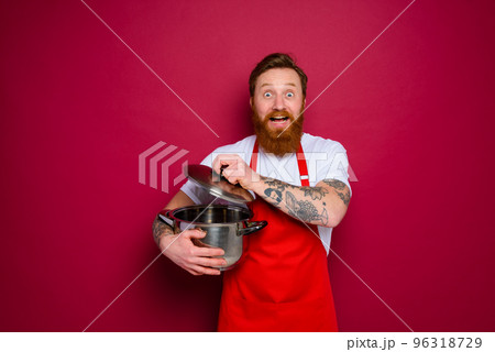 surprised chef with beard and red apron is ready to cook 96318729