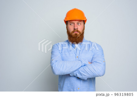 Isolated doubter architect with beard and orange helmet 96319805
