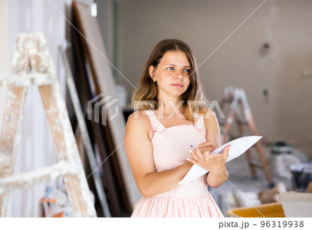 Woman construction manager checking project documentation Woman construction manager checking project documentation 96319938