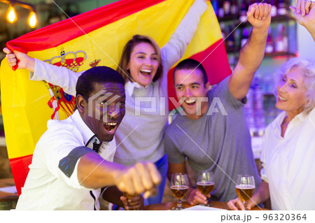 Diverse group celebrating with Spanish flag 96320364