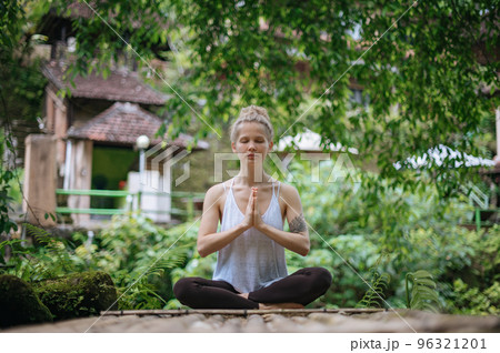 Girl practice yoga meditation outdoor in park 96321201