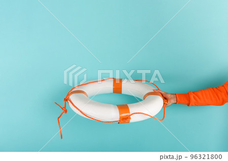 Man helps something with a lifebelt. concept of assistance. cyan background Man helps something with a lifebelt. concept of assistance. cyan background 96321800