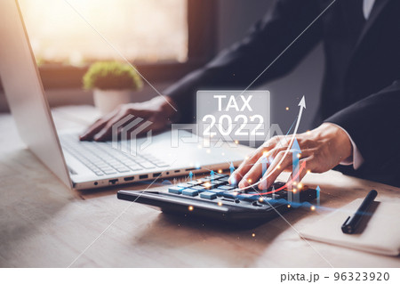 Tax 2022 of Individual income paid and corporations concept. Businessman using a calculator and laptop (notebook) of Data analysis, Paperwork, financial research, and report. 96323920