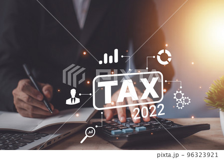 Tax 2022 of Individual income paid and corporations concept. Businessman using a calculator and laptop (notebook) of Data analysis, Paperwork, financial research, and report. 96323921